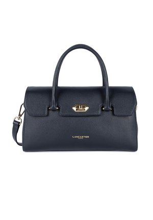 Sac en cuir bleu marine avec double poignées, une forme structurée, des accessoires en métal et un logo doré à l'avant. Comprend une bandoulière détachable.