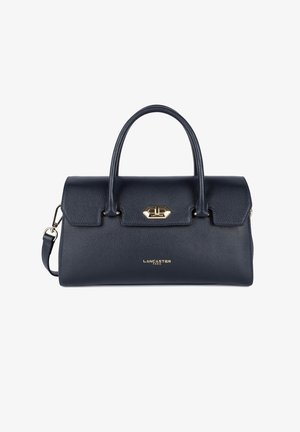 Borsa in pelle blu navy con doppi manici, forma strutturata, hardware in metallo e logo dorato sul davanti. Include una tracolla rimovibile.