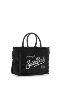 Sac cabas en toile noire avec deux anses, orné de bords à franges et d'un texte brodé en blanc : "Rêver du Paradis hivernal de Saint Barth."