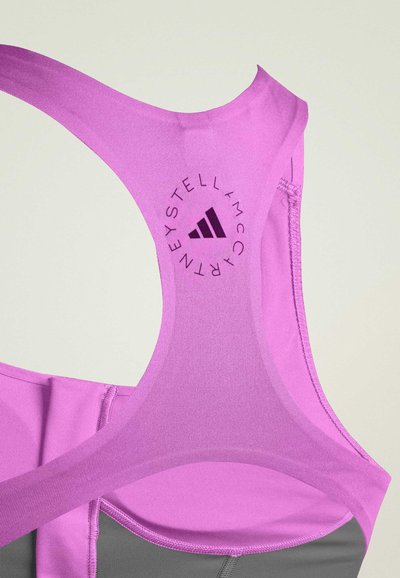 Purple athletic bra with a smooth fabric, racerback design, and embroidered logo details. Features contrasting gray underlayer.