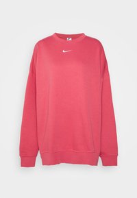 Rosa sweatshirt gjort av bomull med rund hals, långa ärmar, ribbade mudd och en vit Nike-logotyp på bröstet. Slät textur.