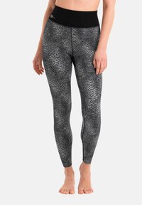 Leggings neri a vita alta con un motivo in pelle di serpente testurizzato bianco. Realizzati in tessuto elastico, presentano una vita liscia.