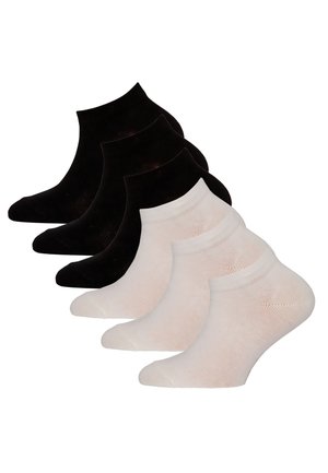 Three pairs of black ankle socks stacked behind three pairs of white ankle socks on a white background.