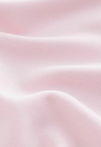 Light pink satin fabric with smooth texture, subtle sheen, and soft drape, featuring gentle folds and curves.
