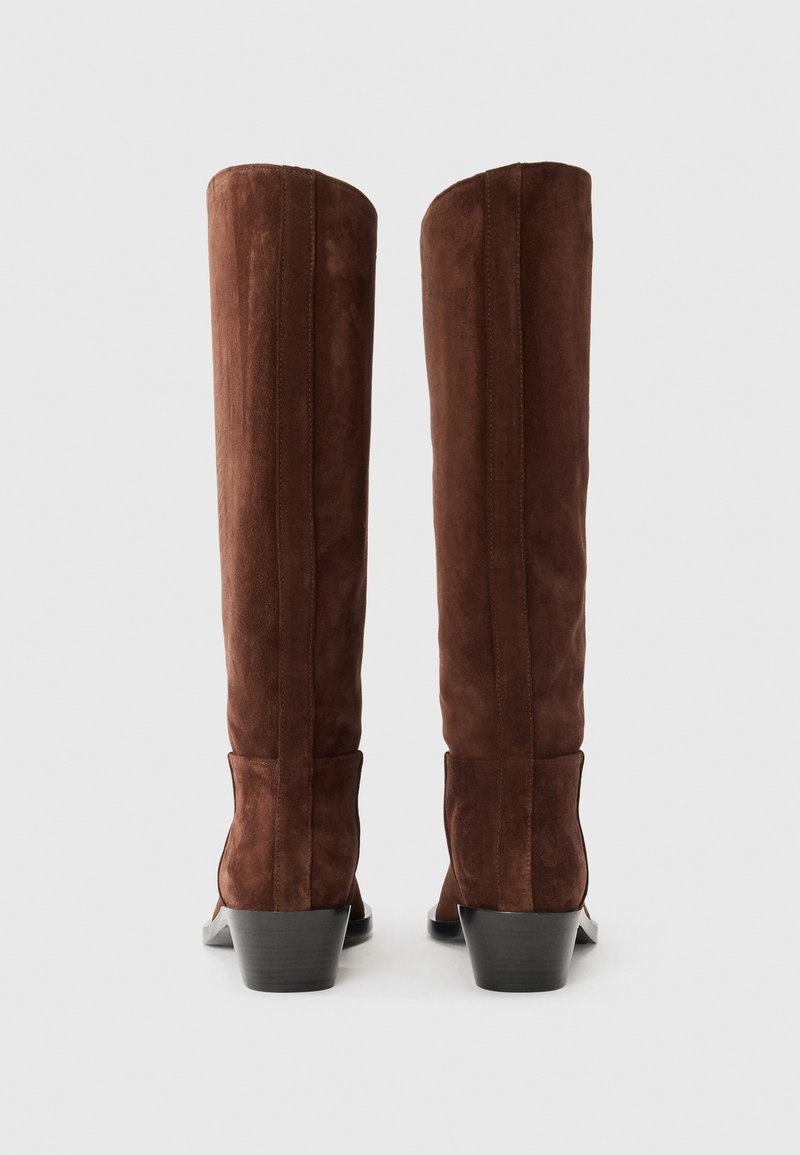 Brown suede knee-high boots with a slightly tapered heel, featuring vertical seam details and a smooth finish on the boot exterior.