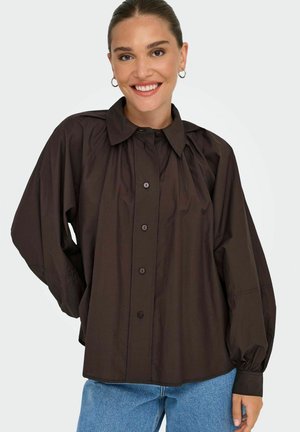 Brown button-up shirt with a pointed collar, balloon sleeves, and a relaxed fit. The fabric appears smooth with a slight sheen.