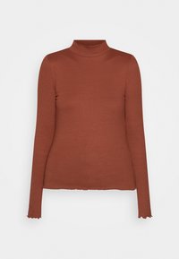 Rippiger Rollkragenpullover in Rostfarbe, mit langen Ärmeln, figurbetonter Silhouette und gewelltem Saum. Weiches, elastisches Material.