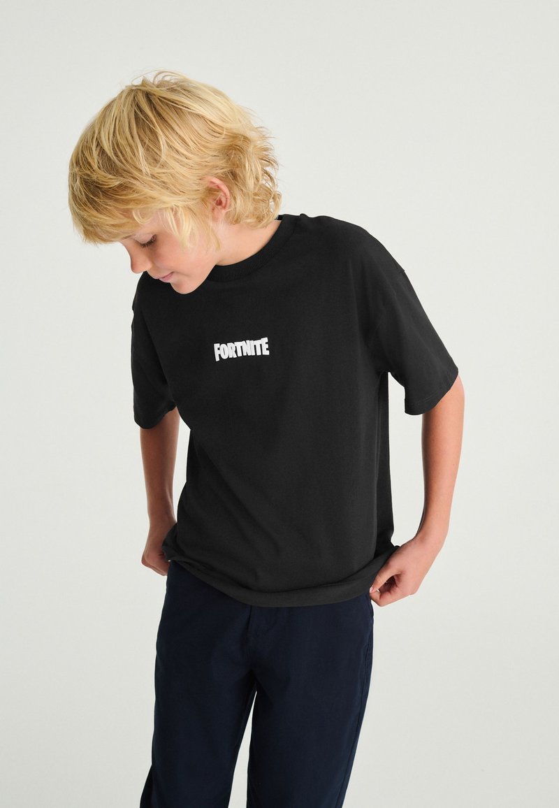 Epic Games T-Shirt Originale Fortnite Bambino Ragazzo Cubo Maglia Nera Maglietta (12/13 Anni