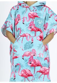 Hooded turquoise poncho with pink flamingo and green leaf patterns, featuring a front pocket and soft, textured material.