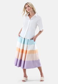 White button-up shirt paired with a multi-colored pleated skirt featuring horizontal stripes in blue, orange, peach, and lavender.