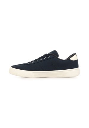 Low-top black canvas sneaker with white rubber sole and laces, viewed from the side on a white background.