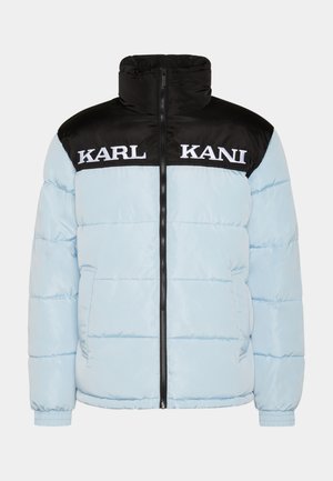 Light blue puffer jacket with a black zippered collar and sleeves. Features large white "KARL KANI" text across the chest. Textured design.