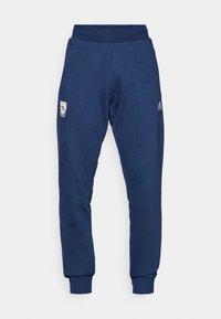 Navy blue joggers made of soft fabric, featuring an elastic waistband, tapered leg cuffs, and side pockets with a logo on the left hip.