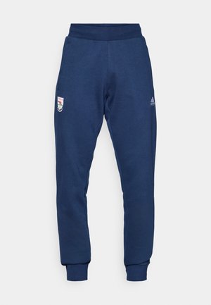 Joggers blu navy realizzati in tessuto morbido, caratterizzati da una vita elasticizzata, polsini con gamba affusolata e tasche laterali con logo sull'anca sinistra.
