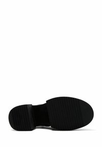 Black rubber shoe sole with a textured, ribbed surface. Features a rounded shape at the toe and a flat heel for stability.