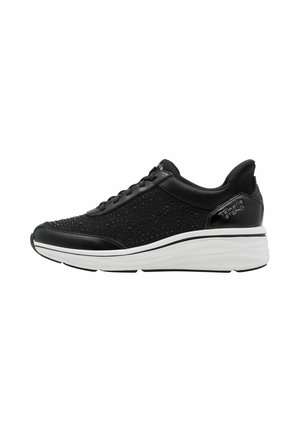 Black sneaker with perforated fabric upper, smooth leather accents, white cushioned sole, and textured detailing along the sole’s edge.