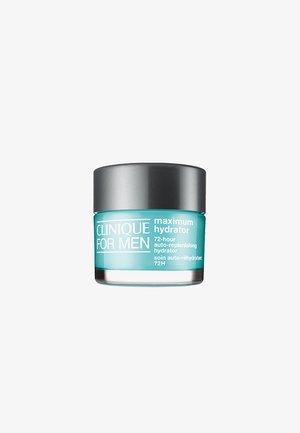 Clinique pour Hommes Maximum Hydrator, un pot en verre givré avec un corps teal, un couvercle gris et un texte blanc, conçu pour une hydratation de 72 heures.