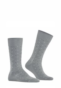 Graue Socken mit einem gerippten Bündchen, die ein gepunktetes Muster in Schwarz und Weiß aufweisen. Hergestellt aus weichem, atmungsaktivem Material mit nahtlosen Zehen.
