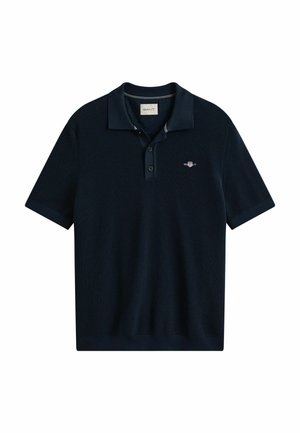 Polo a maniche corte blu navy con abbottonatura e piccolo logo ricamato sul petto a sinistra.