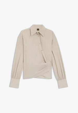 Randig blus i ljusbeige och krämfärg, med krage, knäppning och långa puffärmar med rynkade manschetter. Mjukt, slätt tyg.