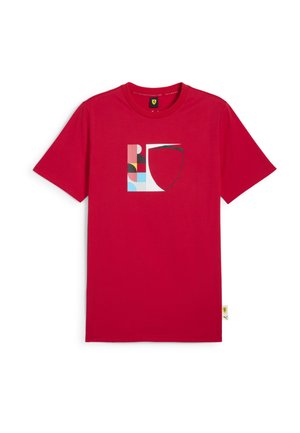 Red cotton t-shirt featuring a multicolored graphic logo with geometric shapes. Crew neck and short sleeves, tag at the bottom left.