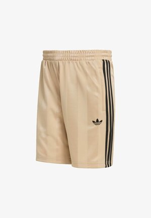 Pantaloncini sportivi beige con strisce verticali nere, fascia elastica in vita e un piccolo logo nero sulla gamba sinistra. Texture liscia e design aderente.