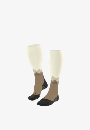 Coppia di calzini al ginocchio con parte superiore crema, motivo montano marrone e grigio, e sezioni di punta e tallone nere etichettate L e R.