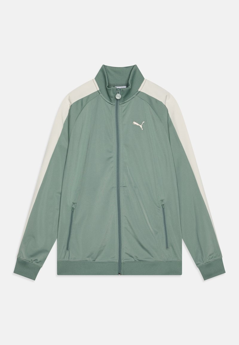 Jacket by Puma in olive green, featuring a zip closure, high collar, white shoulder panels, and side pockets. Smooth fabric texture.