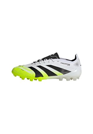 White and neon yellow Adidas Predator soccer cleat with black stripes and molded studs, side view on a white background.