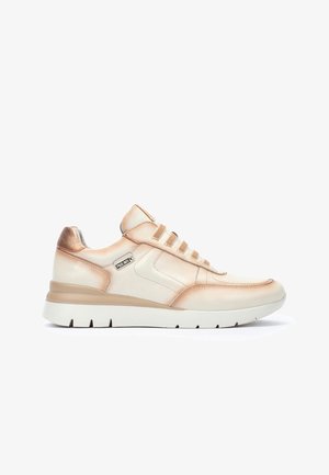 Zapatillas de color claro con un upper de cuero liso, acentos en oro rosa, detalles laterales texturizados y una suela de goma blanca.