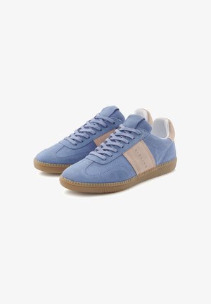 Light blue suede sneakers with beige accents and textured rubber soles, featuring a lace-up design and rounded toe.