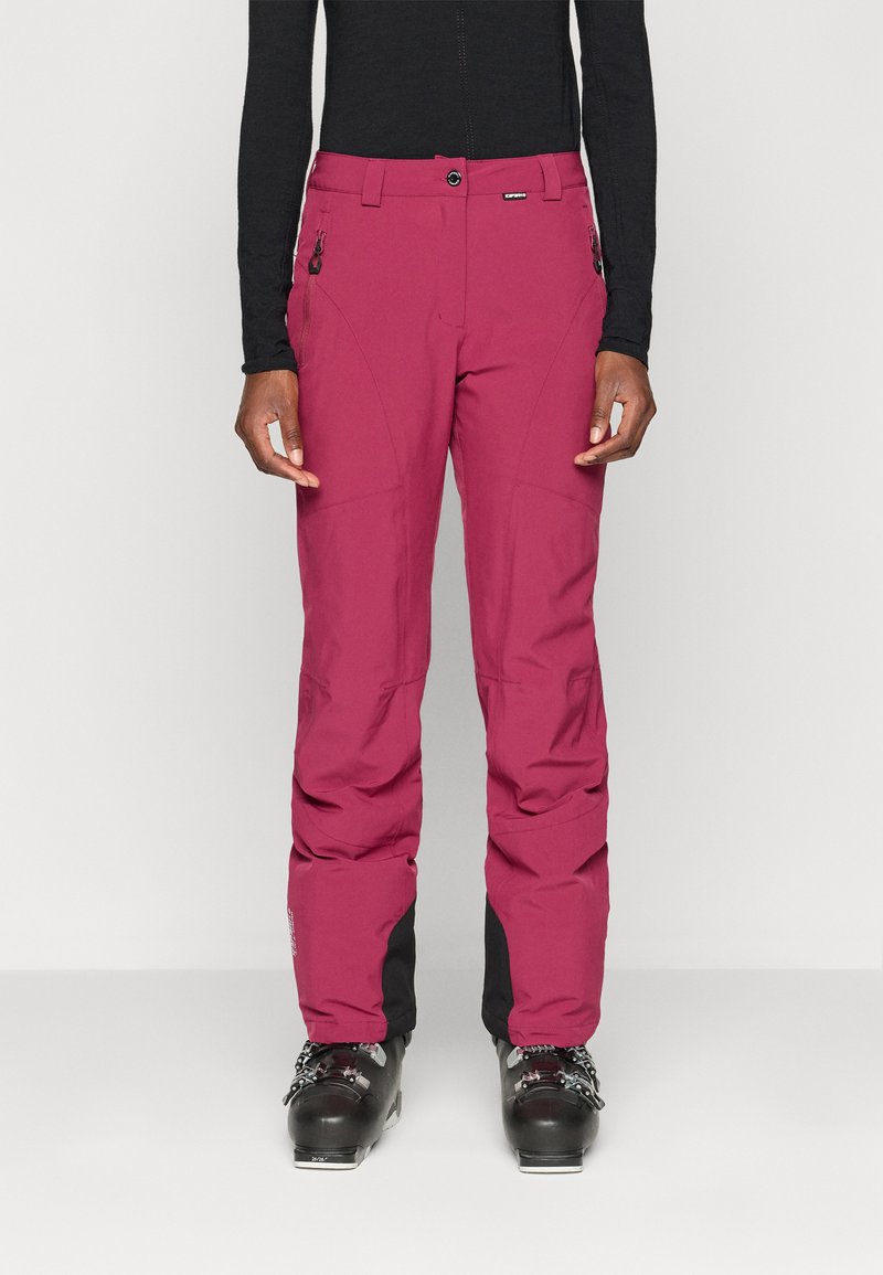 Élénk magenta színű sínadrág, letisztult dizájnnal, cipzáras zsebekkel és fekete díszítéssel a szárak végén. Simább, tartós anyagból készült.