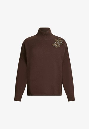 Brown turtleneck sweater with a textured knit, featuring a decorative cluster of clear and metallic gemstones on the left shoulder.