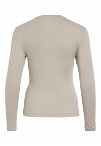 Långärmad skjorta i ljusbeige, med rund hals, figursydd design och mjuk textur utan synliga mönster eller detaljer.
