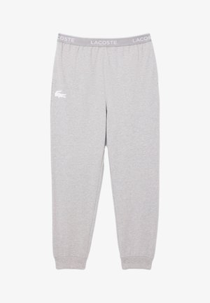 Világosszürke Lacoste melegítőnadrág, elasztikus derékrésszel, a bal combján "LACOSTE" felirattal és fehér krokodil logóval.