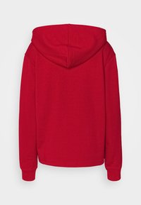 Red hooded sweatshirt featuring a soft texture, long sleeves, and a relaxed fit. The back has a rounded hem and an adjustable hood.