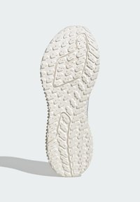 Suola di scarpa in gomma bianca con motivo di grip testurizzato, caratterizzata da segmenti in rilievo e indentazioni circolari, che evidenziano un design di durabilità e trazione.