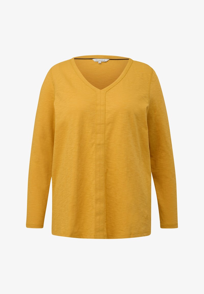 Chemise à manches longues jaune moutarde avec col en V et détail de couture subtil au centre avant, fabriquée en tissu léger texturé.