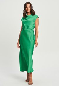 Long green satin dress with cap sleeves and a gathered waist. The fabric has a smooth texture and a sleek, flowing design.