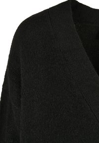 Black cardigan with a soft, textured knit. Features a deep V-neck and a relaxed fit, highlighting the material's warmth and comfort.