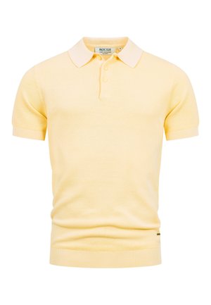 Bladożółta koszulka polo z krótkim rękawem z teksturowanej tkaniny, prążkowanymi mankietami i dołem, listwą z trzema guzikami oraz miękkim, ostrym kołnierzem.