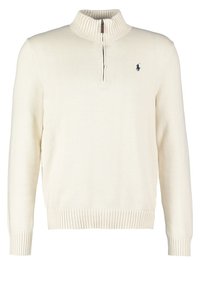 Krämfärgad stickad tröja med hög ribbad krage och kvartslång dragkedja. Har ribbade manschetter och nederkant, samt en liten marinblå logotyp på bröstet.