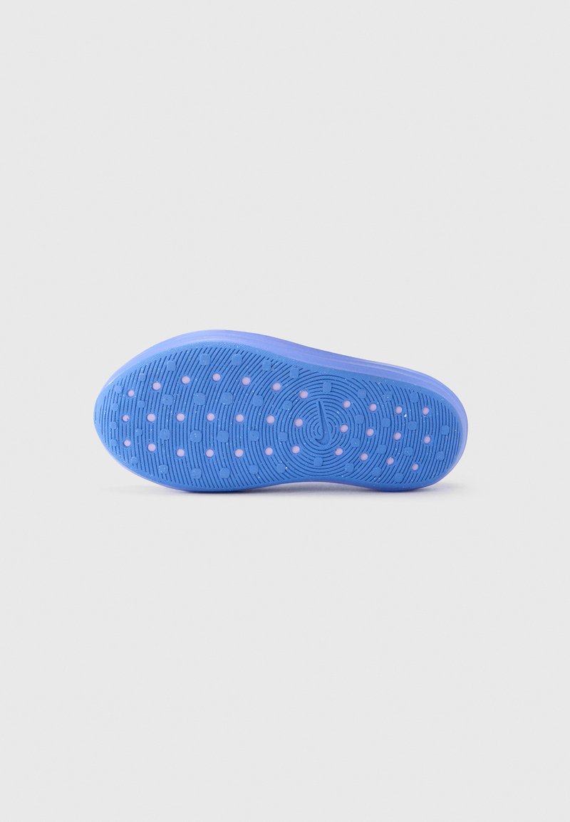 Blue rubber shoe sole with textured surface and circular pattern. Features small pink dots for added grip and traction.