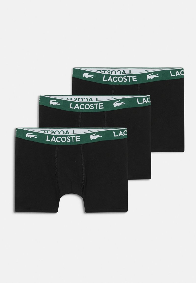 Mustad mustad mustad musta musta Lacoste elastikuga roheline ja valge värviga, sileda tekstuuri ja keskmise reiega lõikega. Müüakse kolmes komplektis.