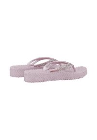 Chanclas de color púrpura claro con suelas gruesas y texturizadas y dobles tiras brillantes, mostradas una al lado de la otra sobre un fondo blanco.