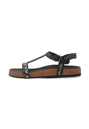 Black strappy sandal with metallic accents, cork sole, textured footbed, and adjustable ankle strap. Features a textured design on straps.