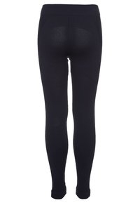 Leggings noirs avec une texture lisse, une taille haute et un design ajusté. Détails de couture visibles au dos. Longueur complète avec des poignets aux chevilles.