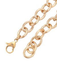 Catene ovali di colore oro con texture, con moschettone oro inciso con "dX" su uno sfondo bianco.