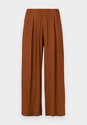 Wide-legged trousers in burnt orange, featuring a textured fabric, an elastic waistband, and front pleats for a relaxed fit.