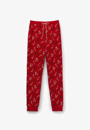 Red pajama pants featuring a candy cane and holly pattern. Made of soft fabric with an elastic waistband and drawstring. Cuffed hems.
